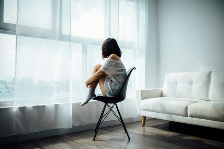 Woman staring out the window thinking of life