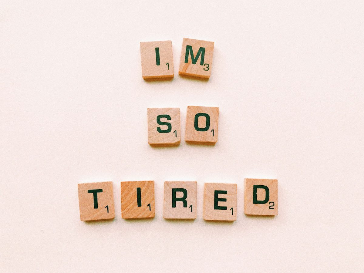 Scrabble letters spelling out ‘I’m so tired,’ symbolizing quiet burnout and emotional fatigue in low-stress jobs.