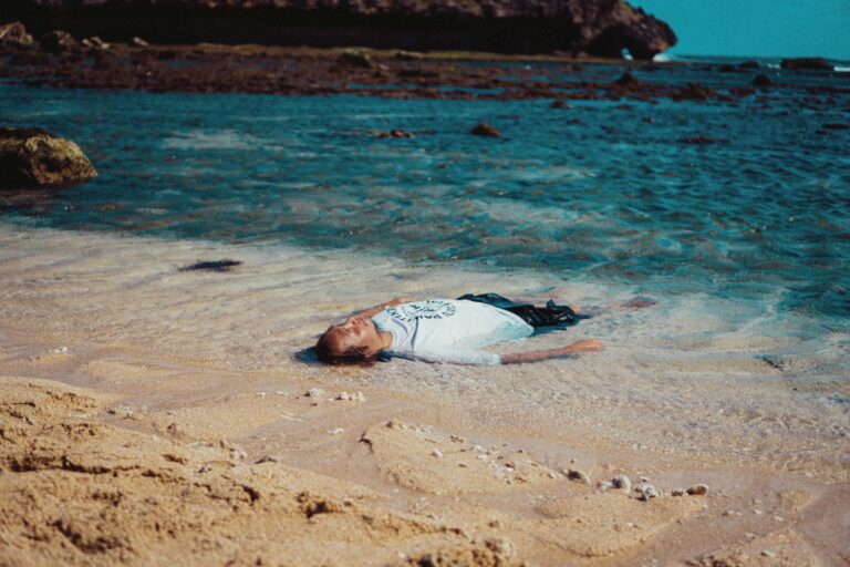 individual alone in water at beach representing emotional exhaustion, career burnout,