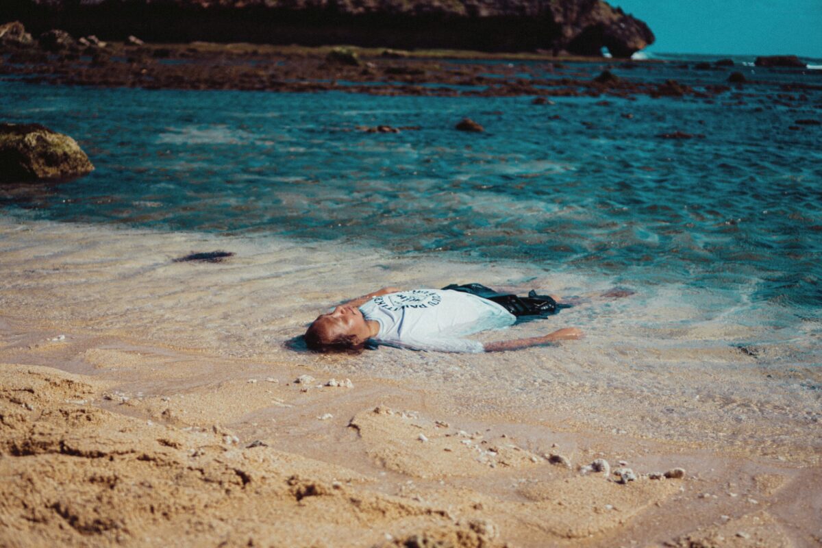 individual alone in water at beach representing emotional exhaustion, career burnout,