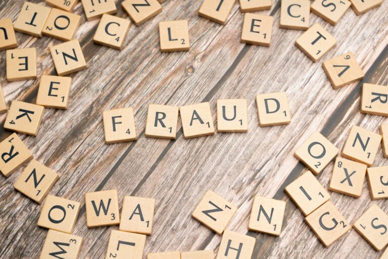 Scrabble letters spelling ‘fraud,’ symbolizing imposter syndrome in grief.