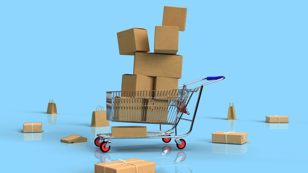 A shopping cart stacked with too many boxes, symbolizing overwhelm and the pressure of making purchase decisions.
